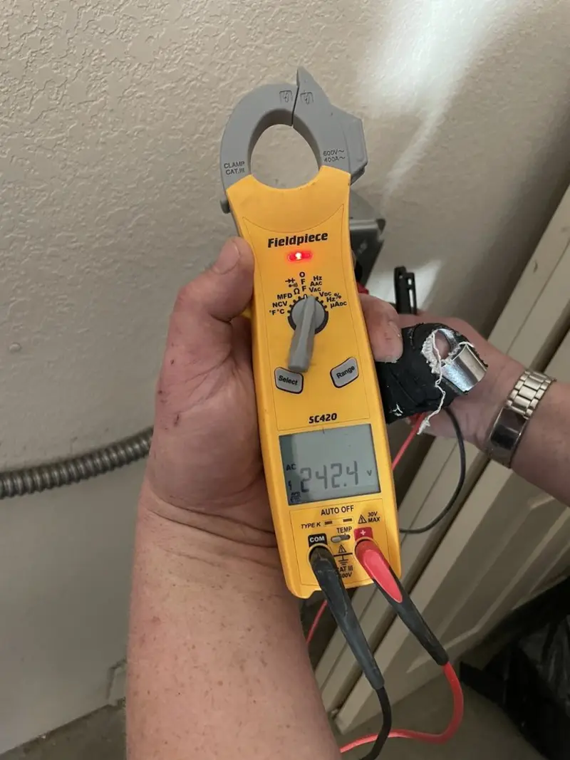 Voltage testing with clamp meter during Ceiling Fan Installation in Plymouth